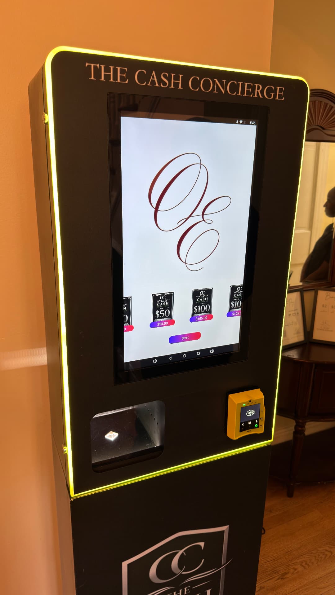 The Cash Concierge cash machine with its glowing frame and touchscreen at a real event