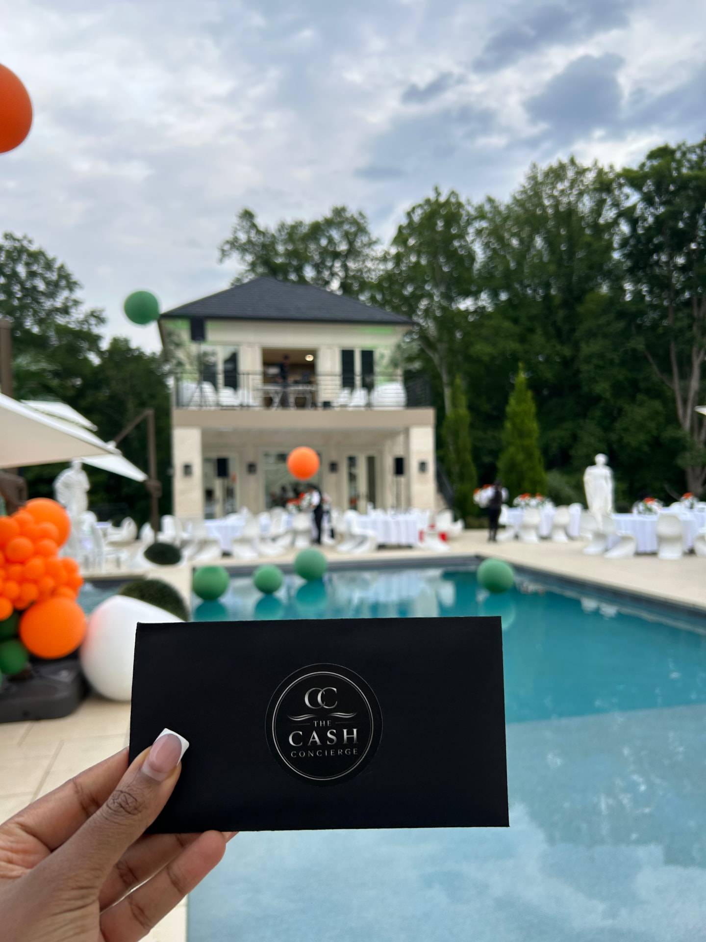 A Cash Concierge envelope at an outdoor poolside celebration
